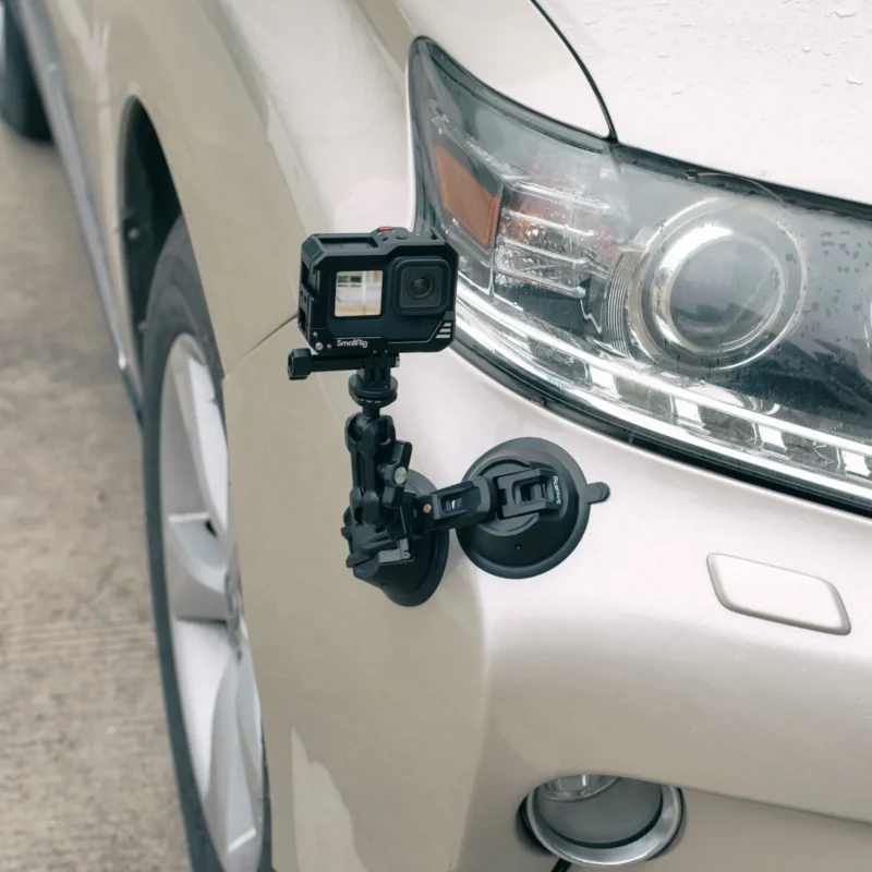 Action camera on a suction cup mount next to a car headlight