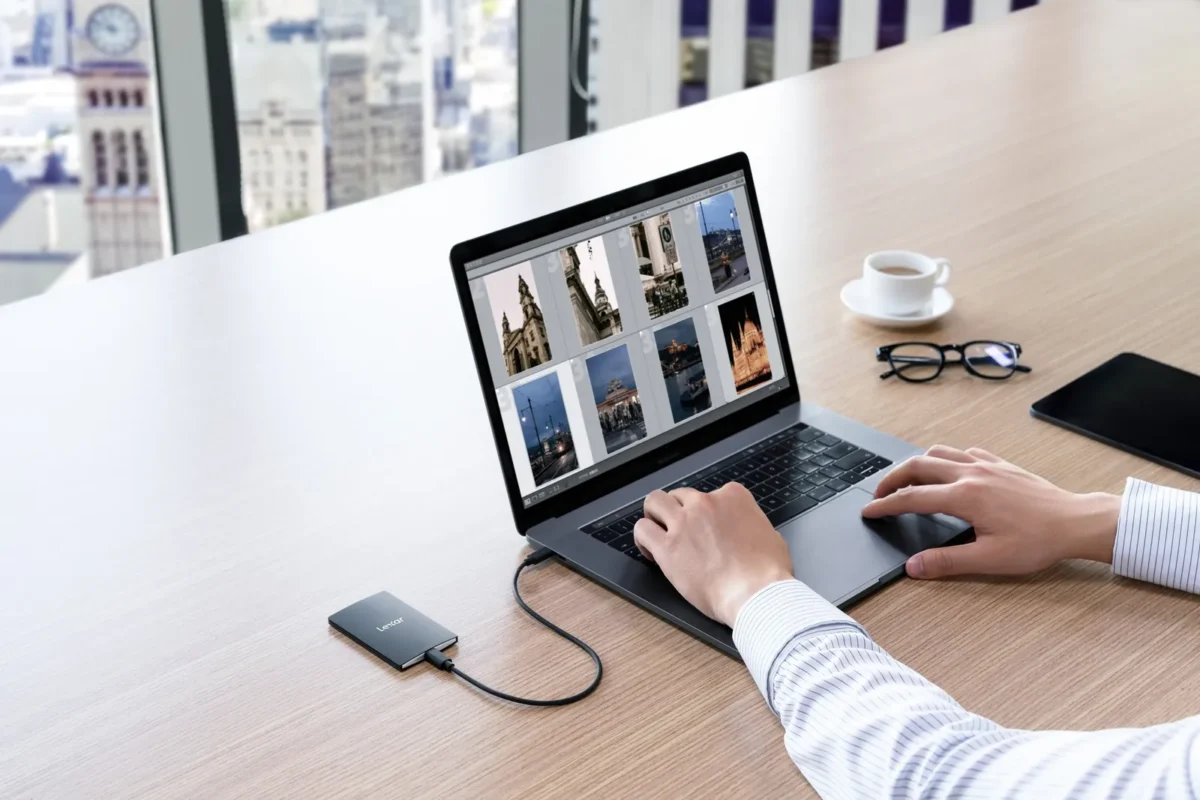 Editing photos on a laptop with an external SSD plugged in