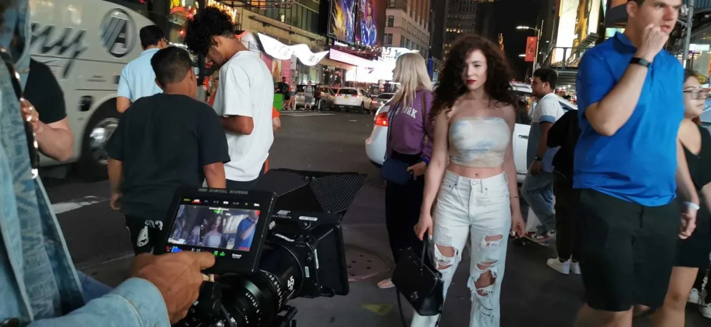 Filmmaker in the street with a camera rig running on an external battery