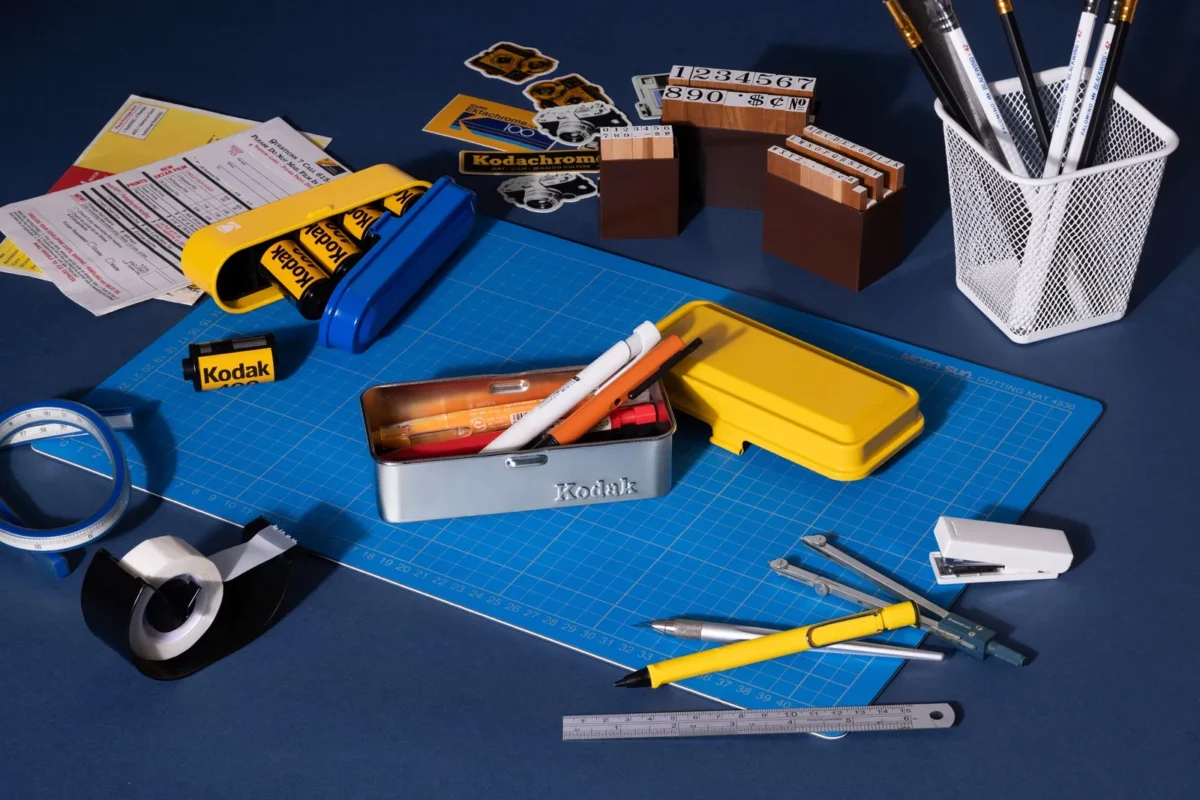 Film cases and tools on a blue desk, seen from above