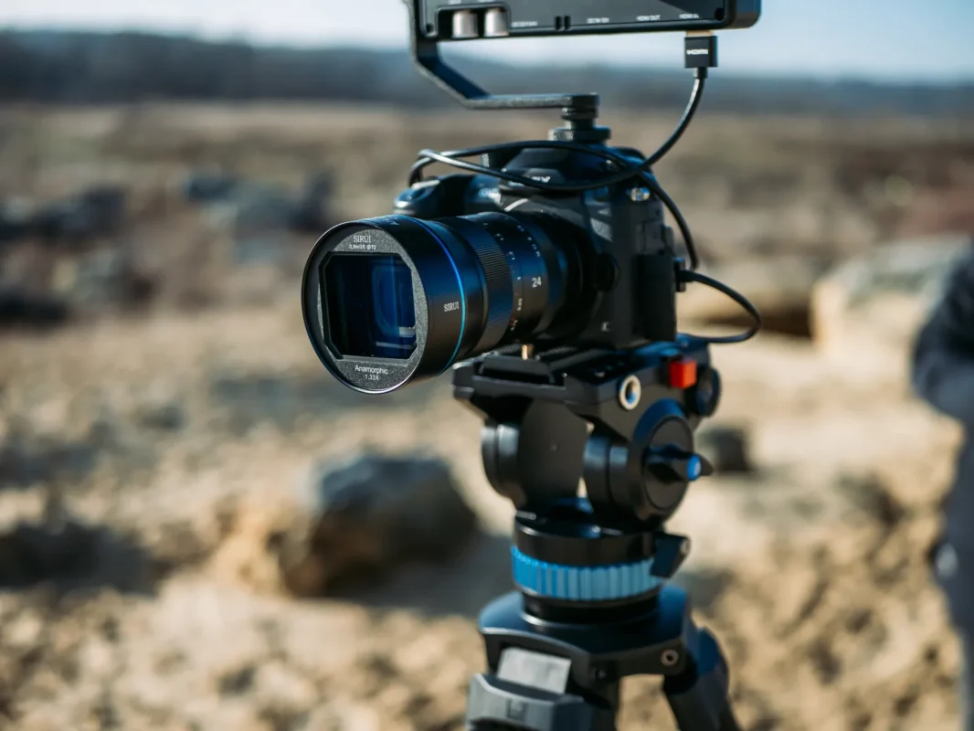 Cinema camera on a tripod with a fluid video head in sunshine