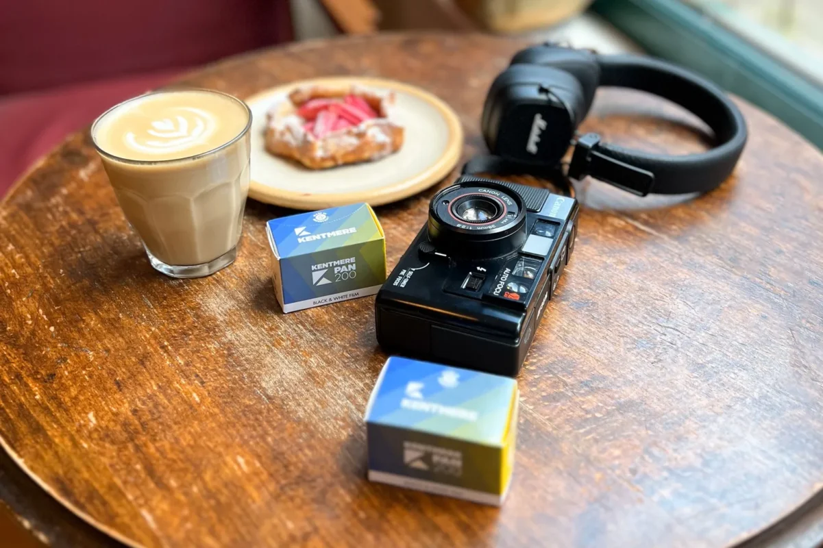 Film boxes, a camera and coffee on a café table