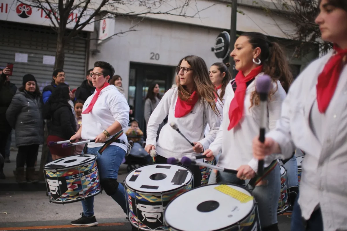 Street drummers in red scarves playing