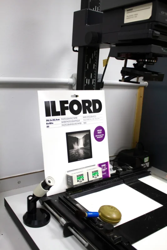 Box of photo paper standing on the baseboard of an enlarger