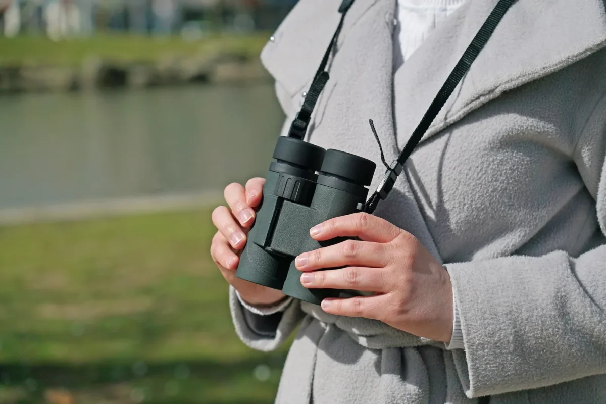 Binoculars hanging from a neck strap