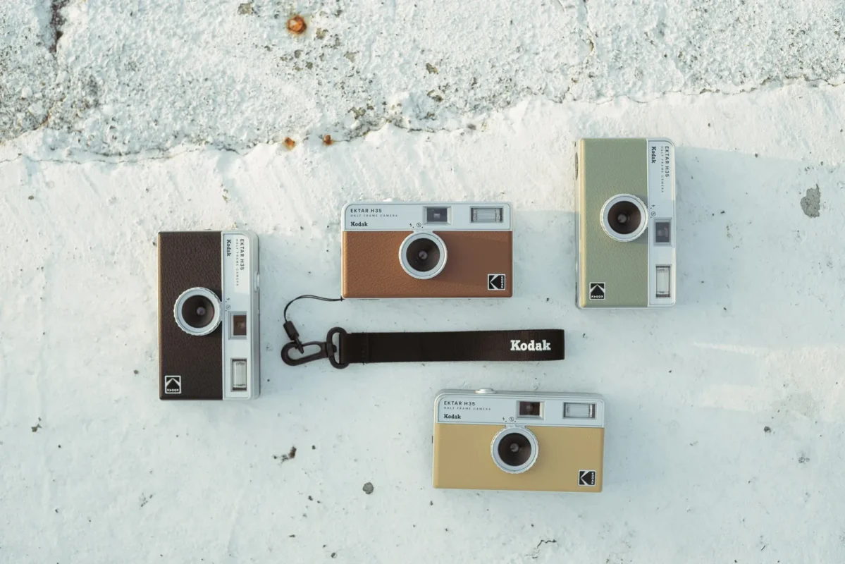 Compact film cameras and accessories laid out on a table, seen from above