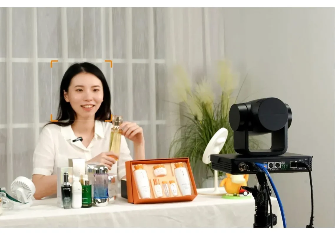 Creator at a desk streaming live with a compact camera