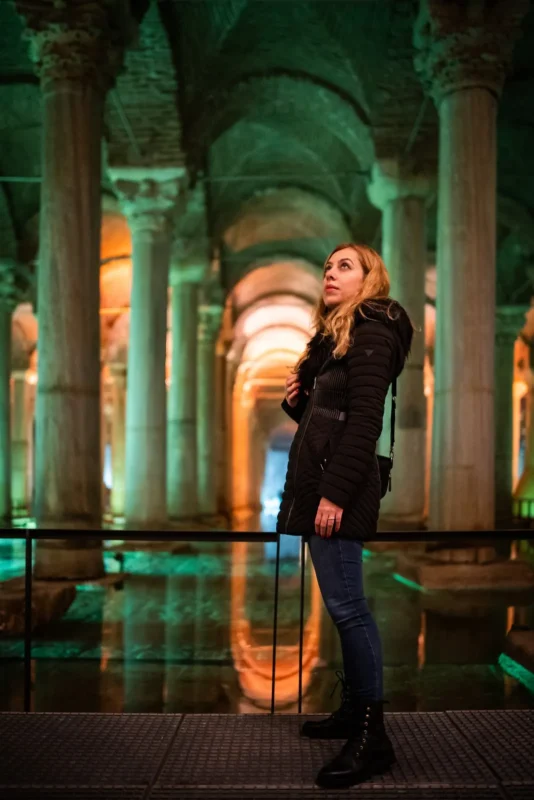 Woman in a lit arcade photographed with a fast lens