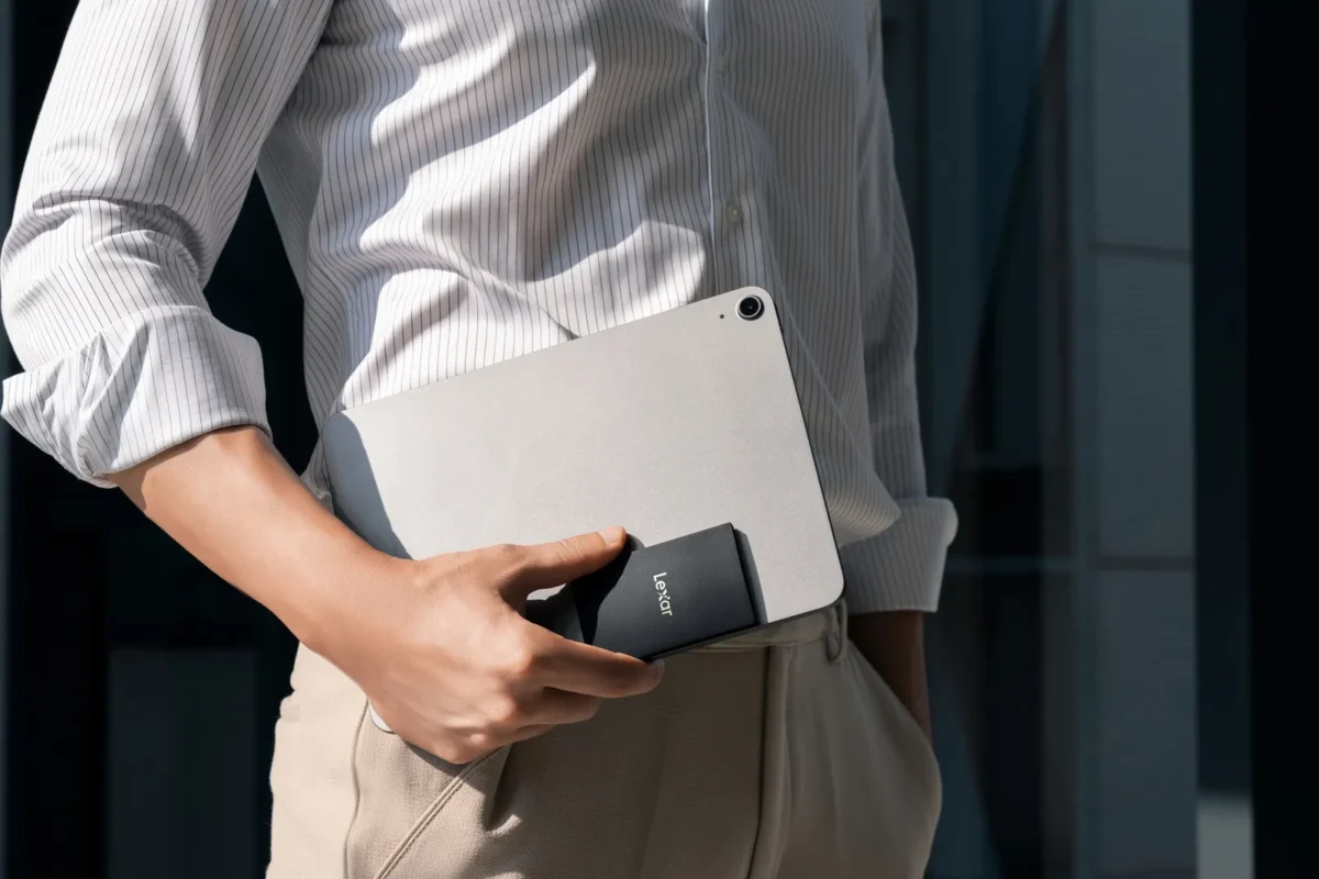 Man holding a pocket-sized SSD by his jacket