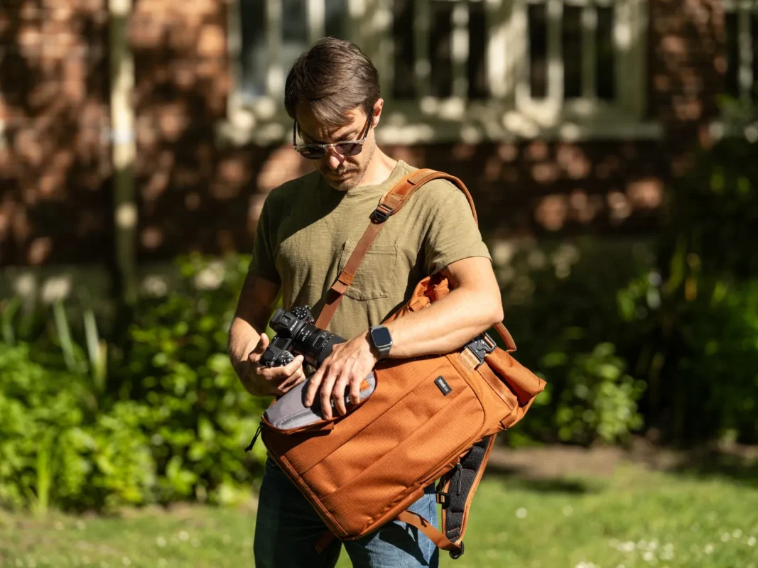 Man in sunglasses with a roll-top backpack