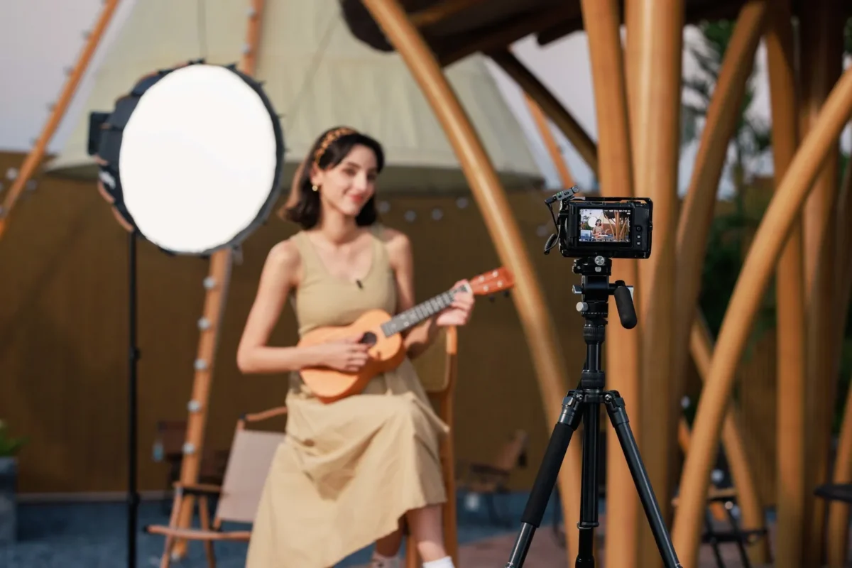Musician records herself with a mic in a sunny studio