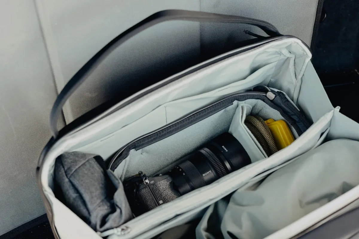 Open bag with a camera insert and lens compartments