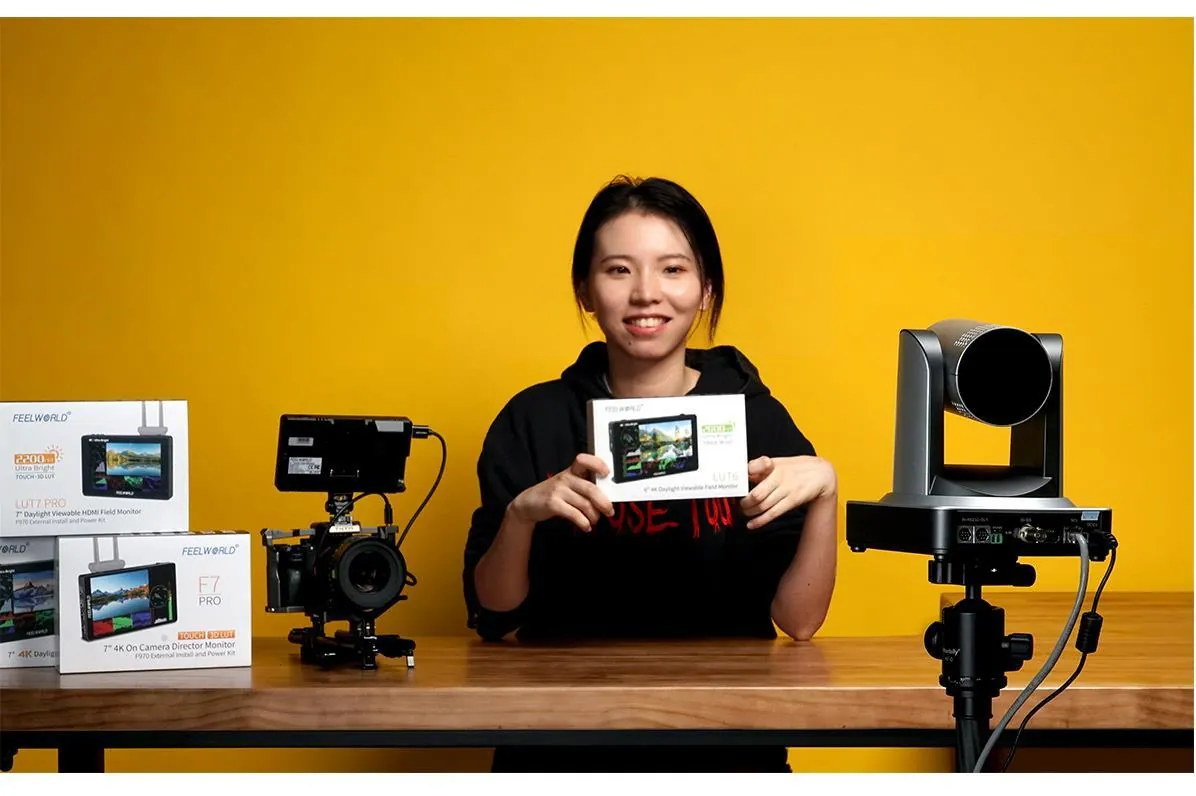 Presenter showing a video mixer in a bright studio
