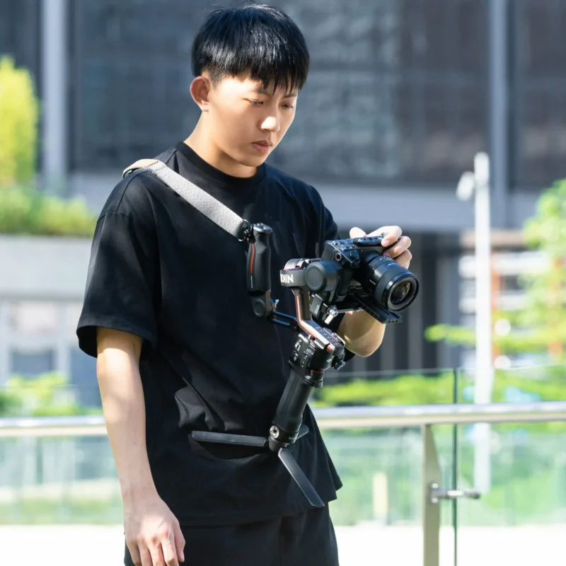 Young man filming a city scene with a camera on a gimbal